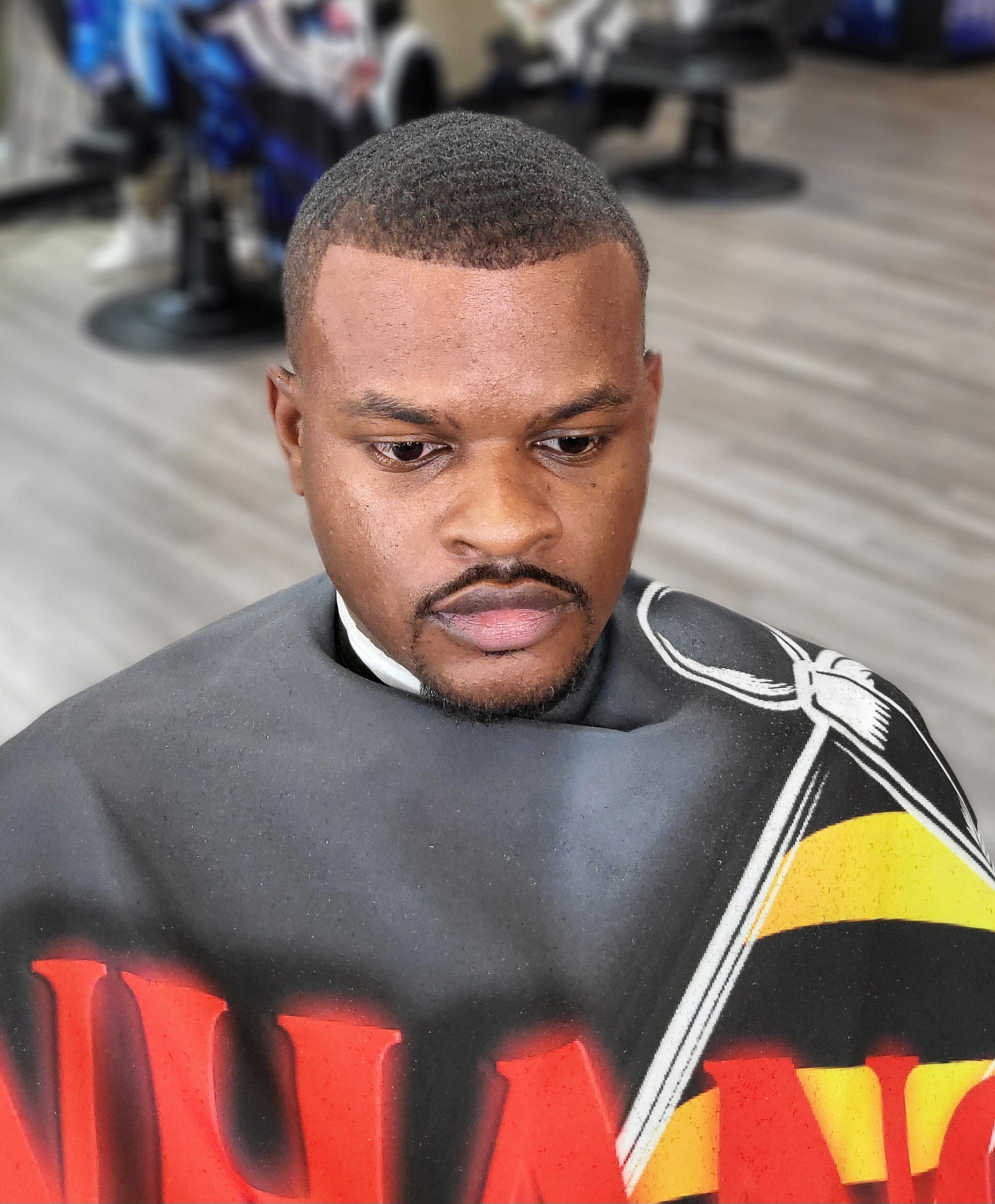 A clean fade and shaped beard on a client in the shop