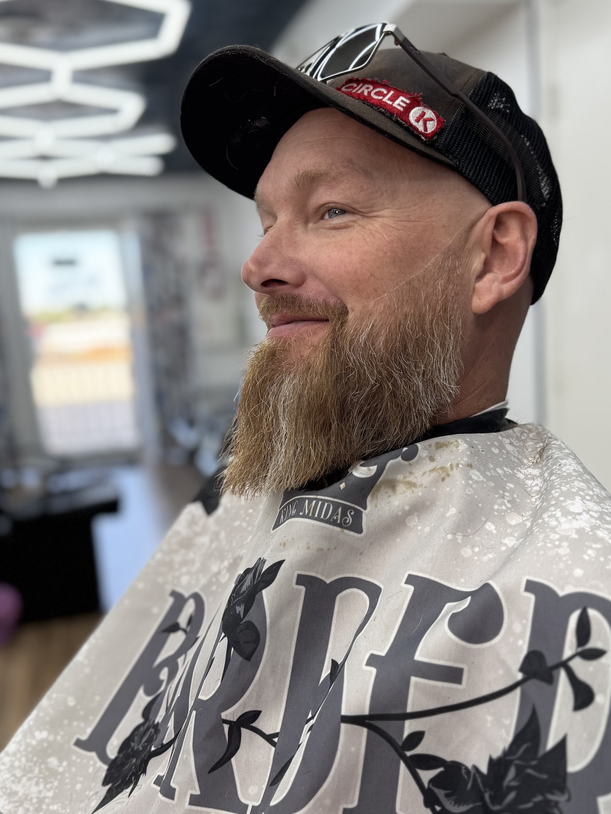 A client smiling with a trimmed full beard